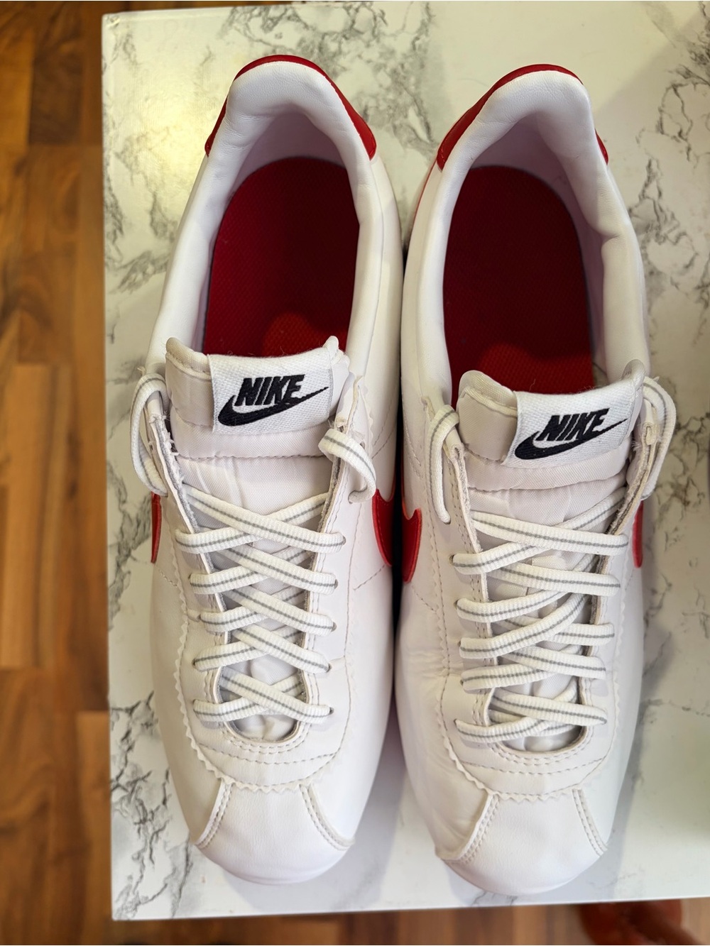Nike Men’s White Leather Sneakers with Red Swoosh and Blue Midsole Accent - Picture 4 of 9